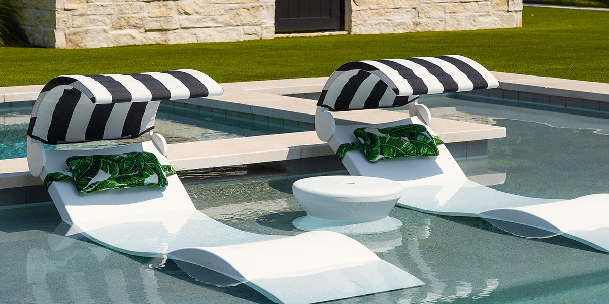 Ledge Signature Chaise loungers with headrest pillows and shades