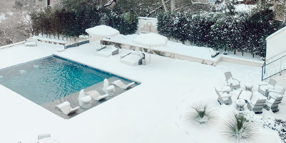 Outdoor space with a pool in the winter