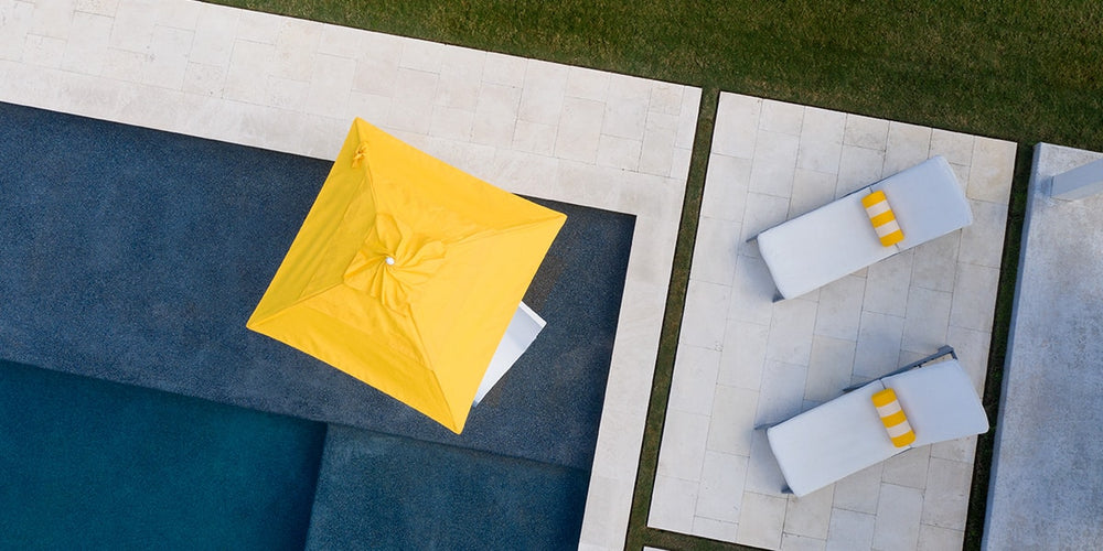 Outdoor space with Ledge chaises and yellow umbrella
