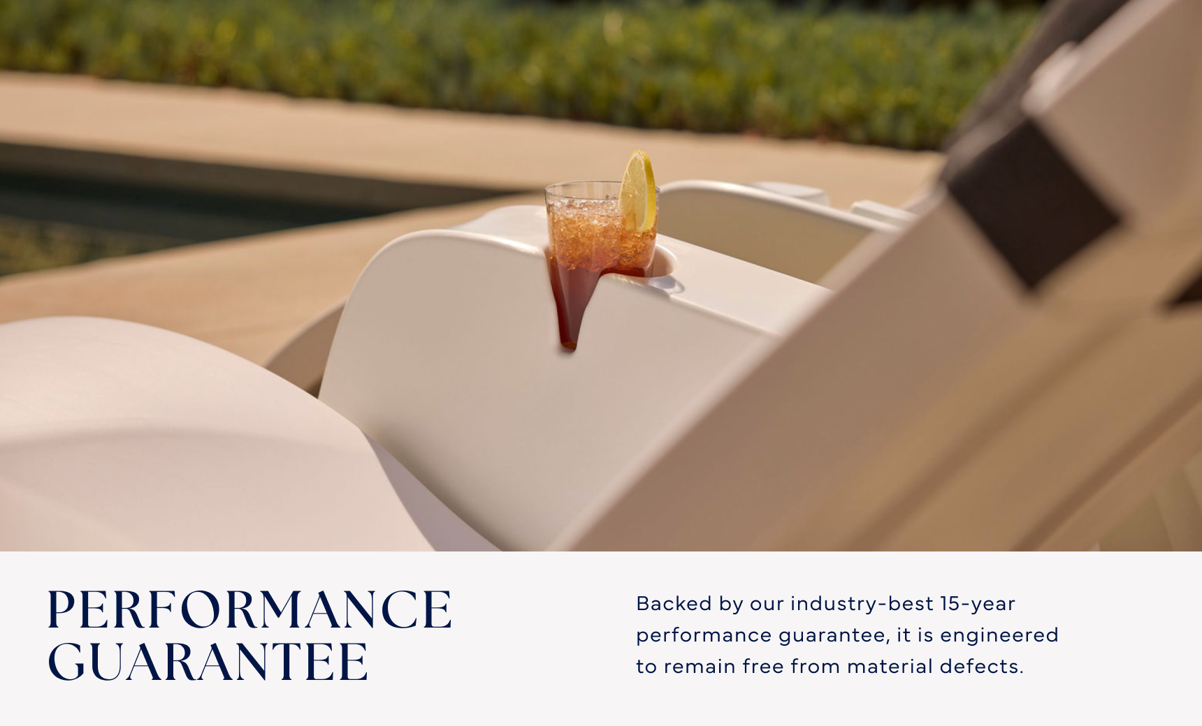 A cold drink with a lemon slice sits on the Signature Chaise Armrest Console by Ledge Lounger, resting on a white outdoor lounge chair by the pool. Enjoy our Performance Guarantee and a 15-year warranty against material defects.