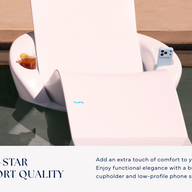 A Ledge Lounger Autograph Chaise Armrest Console in white floats on a tanning ledge, holding a drink and smartphone. Text highlights its five-star resort quality and details this premium pool accessory’s features.