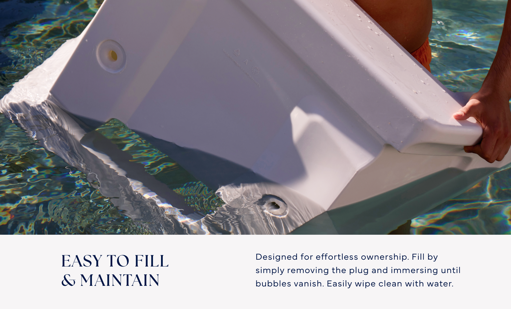 A person submerges the Ledge Lounger Signature Chaise Armrest Console into a pool to fill it with water. Text reads: Easy to fill & maintain—designed for effortless pool ledge use, with straightforward maintenance instructions.