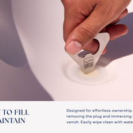 A hand removes a plug from the white Ledge Lounger Autograph Chaise Armrest Console using a metal tool—perfect as a poolside accessory for your tanning ledge. Below, text reads: EASY TO FILL & MAINTAIN, with simple cleaning and filling instructions.