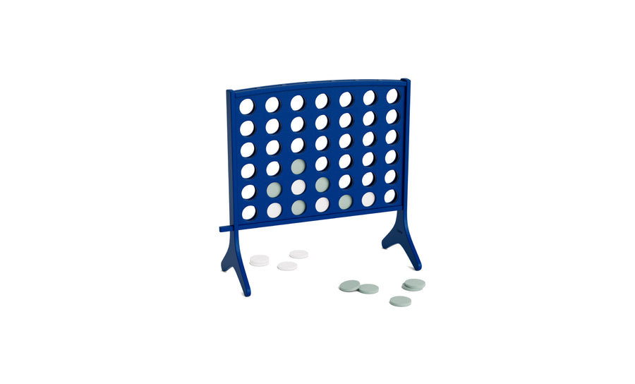 A blue Ledge Lounger Four In A Row game grid stands upright, with several white and gray playing discs scattered across the white surface around it, showcasing this oversized four in a row as a fun and impressive giant outdoor game.