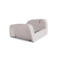 The Ledge Lounger Signature Chaise Armrest Console is a modern, light gray plastic toddler bed with raised safety sides—ideal for relaxing or upright reading—displayed against a plain white background.