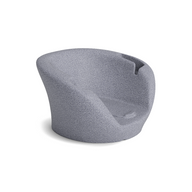 The Ledge Lounger Autograph Chaise Armrest Console features a modern, sculpted silhouette with a curved backrest and seat in textured light gray fabric, boasting seamless lines for stylish relaxation or socializing. Displayed on a white background.