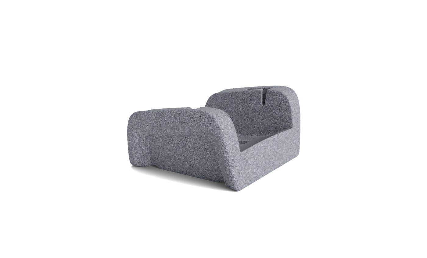 The Signature Chaise Armrest Console by Ledge Lounger features a contoured design with raised sides and a backless structure, offering comfort for reading or relaxing; shown on a white background.