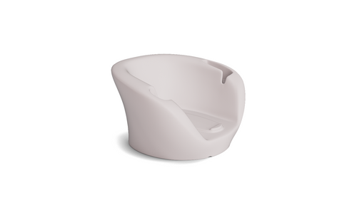 Soft beige plastic baby bathtub with curved backrest, leg support, and side cutout handles, inspired by the Ledge Lounger Autograph Chaise Armrest Console—perfect for a relaxing bath time.