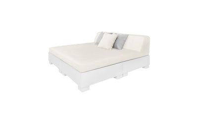 The Affinity Square Sunbed by Ledge Lounger is a minimalist white sectional with a low profile, ideal for outdoor spaces. Its clean design and smooth fabric evoke poolside tranquility. Includes two accent pillows in varying shades atop the solid white background.
