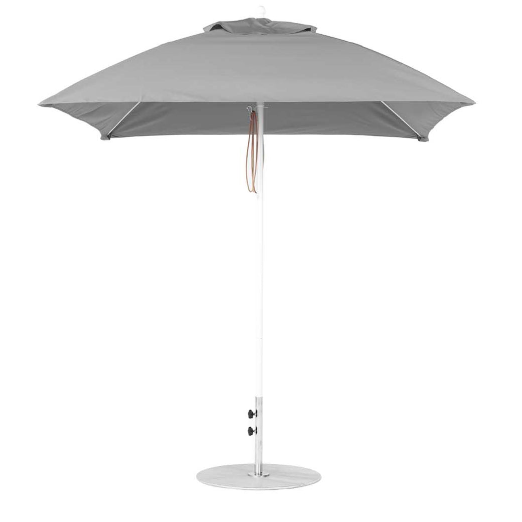 The Ledge Lounger Essential Fiberglass Umbrella - 7.5 Square Pulley, made with marine-grade fabrics, features a straight white pole, round base, short handle with beige strap, and slightly rounded cap. It is perfect for patios and integrates smoothly into the Umbrella Compatibility Matrix.