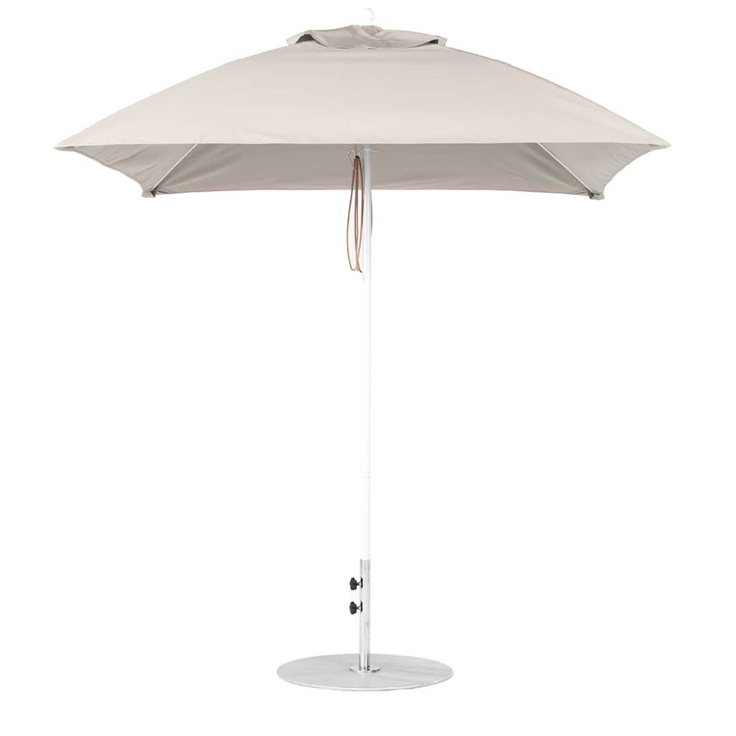 The Ledge Lounger Essential Fiberglass Umbrella - 7.5 features a round canopy crafted from marine-grade fabrics on a sleek metal pole with a circular base, equipped with a tie strap, and is showcased against a plain white background, emphasizing its durability akin to fiberglass umbrellas.