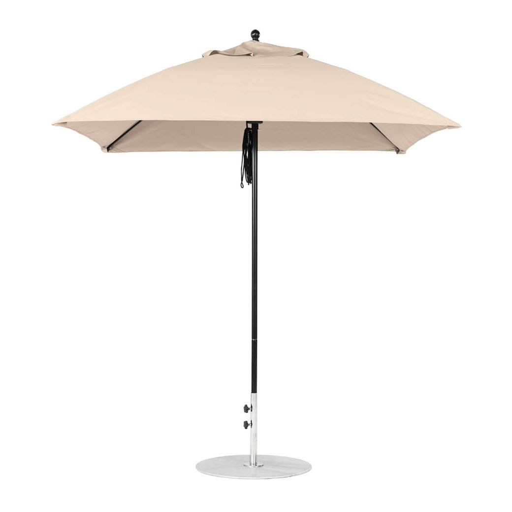 The Ledge Lounger Essential Fiberglass Umbrella, a 7.5 square pulley model in beige, features marine-grade fabrics on a silver pole with a circular base. Its robust design ensures durability and elegance, seen fully open against a plain white background.