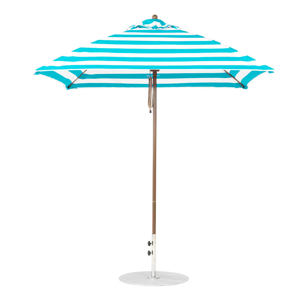 The Ledge Lounger Essential Fiberglass Umbrella - 7.5 Square Pulley features a turquoise and white striped design, a wooden pole with a round base, and is made from durable marine-grade fabrics.