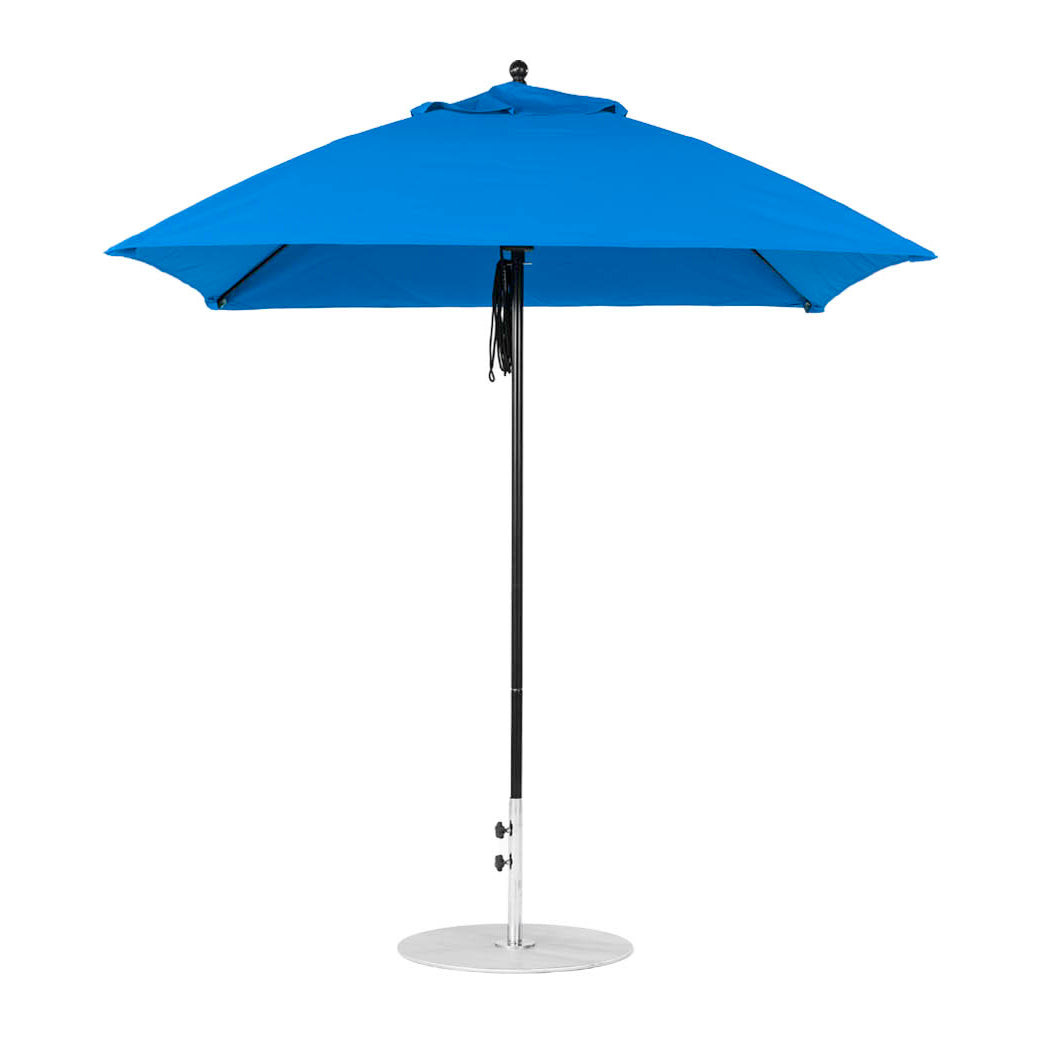 The Essential Fiberglass Umbrella by Ledge Lounger features a 7.5 square design with marine-grade fabric on a pointed top. Its sturdy metal pole rests on a round silver base, combining stylish durability for elegant outdoor shade.