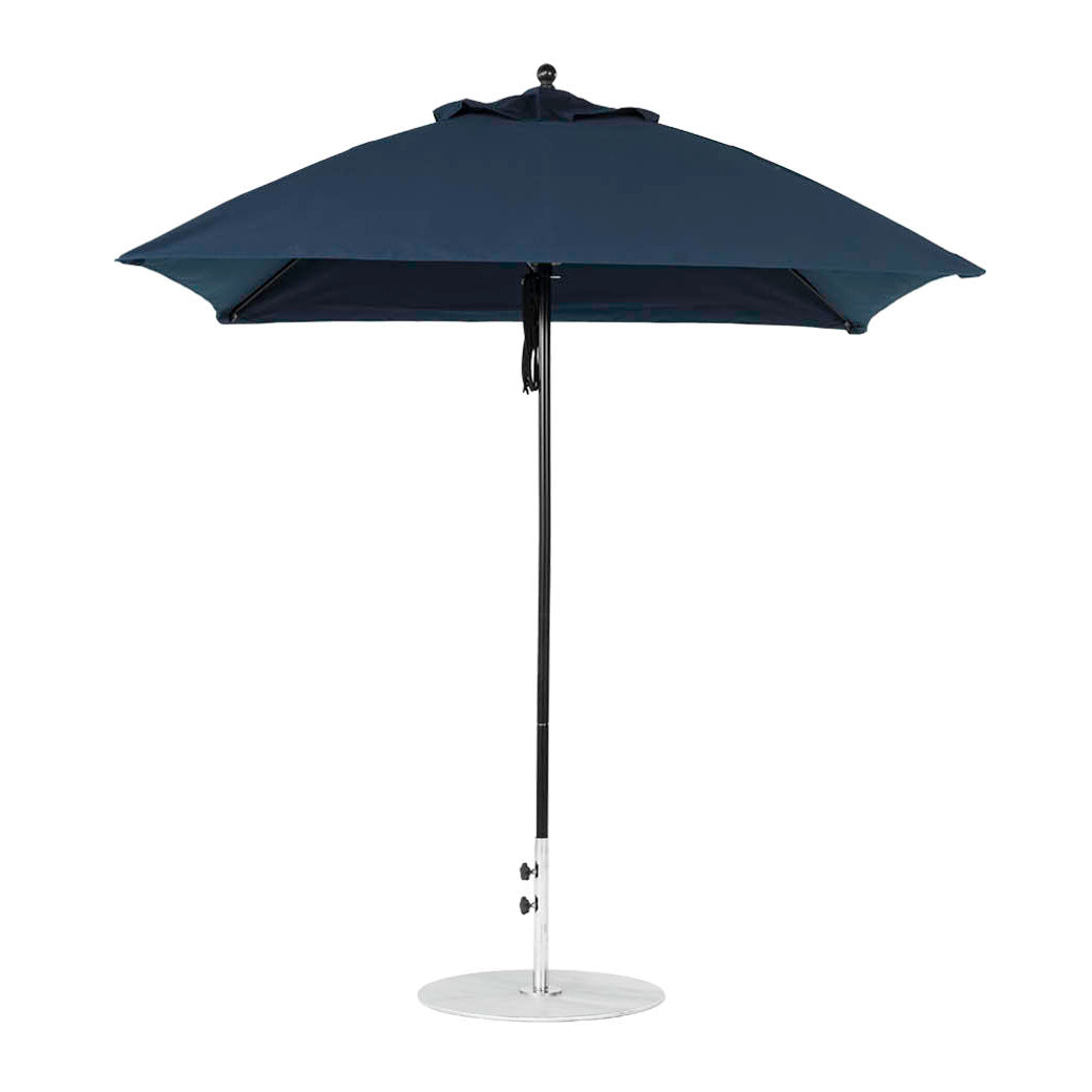 A fully opened Essential Fiberglass Umbrella - 7.5 Square Pulley, by Ledge Lounger, crafted with marine-grade fabrics in dark blue, is supported by a metal pole and round base against a plain white background.