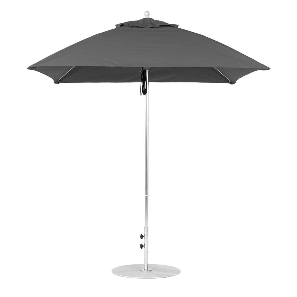 The Essential Fiberglass Umbrella - 7.5 Square Pulley by Ledge Lounger features a closed dark gray canopy of marine-grade fabric, a metal pole, and is set on a round metal base. The sleek, minimalist design stands upright against a white backdrop.