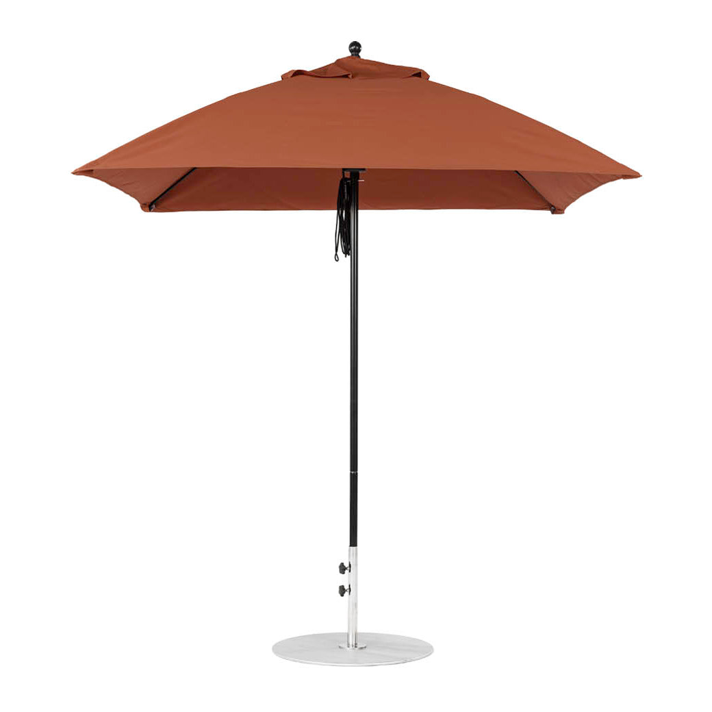 The Essential Fiberglass Umbrella by Ledge Lounger features a tall brown design with a metal pole and round base, showcasing its smooth marine-grade fabric for durability and style in any outdoor setting.