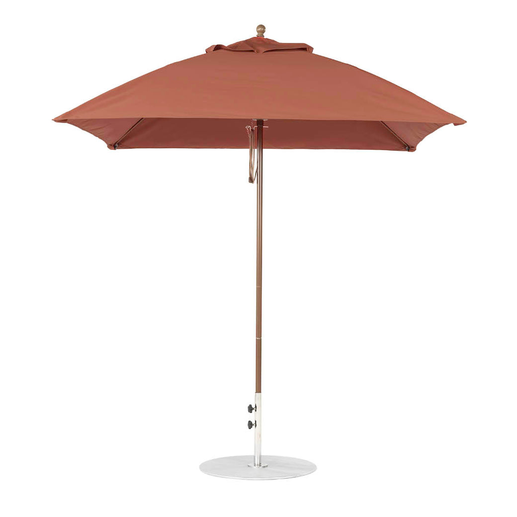 The Ledge Lounger Essential Fiberglass Umbrella, featuring a 7.5 square canopy in red with a straight pole, is open on a round metal base against a plain white background. Made from marine-grade fabrics, it offers durability and style for any garden setting.