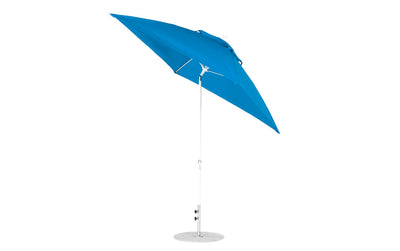 The Ledge Lounger Essential Fiberglass Umbrella - 7.5 Square Crank Auto Tilt has a blue canopy with a sleek metal pole and round base. Made from marine-grade fabrics, its slightly tilted design ensures vibrant color, durability, shade, and enhances outdoor aesthetics.