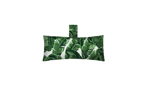 The Autograph Headrest Pillow by Ledge Lounger features a rectangular design with a banana leaf pattern in green shades on white marine-grade fabric. It includes a matching fabric loop at the top, ideal for relaxing in the pool.