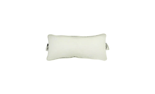 The Signature Headrest Pillow by Ledge Lounger, a rectangular pillow with slightly curved edges in a light color, rests on a white background. It features a small handle and casts a faint shadow, hinting at customizable options for relaxation in the pool.