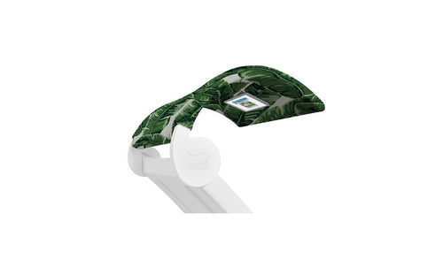 The Ledge Lounger Signature Chaise Shade is a white pool lounge chair with a green leaf-patterned canopy and media viewing window for devices, ensuring ergonomic comfort while you relax.