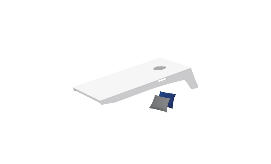 The Ledge Lounger Cornhole set includes a white board with a top hole and two bean bags in blue and gray, elegantly angled against a plain white backdrop, ready for play anywhere.