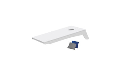 The Ledge Lounger Cornhole Set includes a portable white tabletop board with a hole near the top right corner and comes with a blue and a gray beanbag.