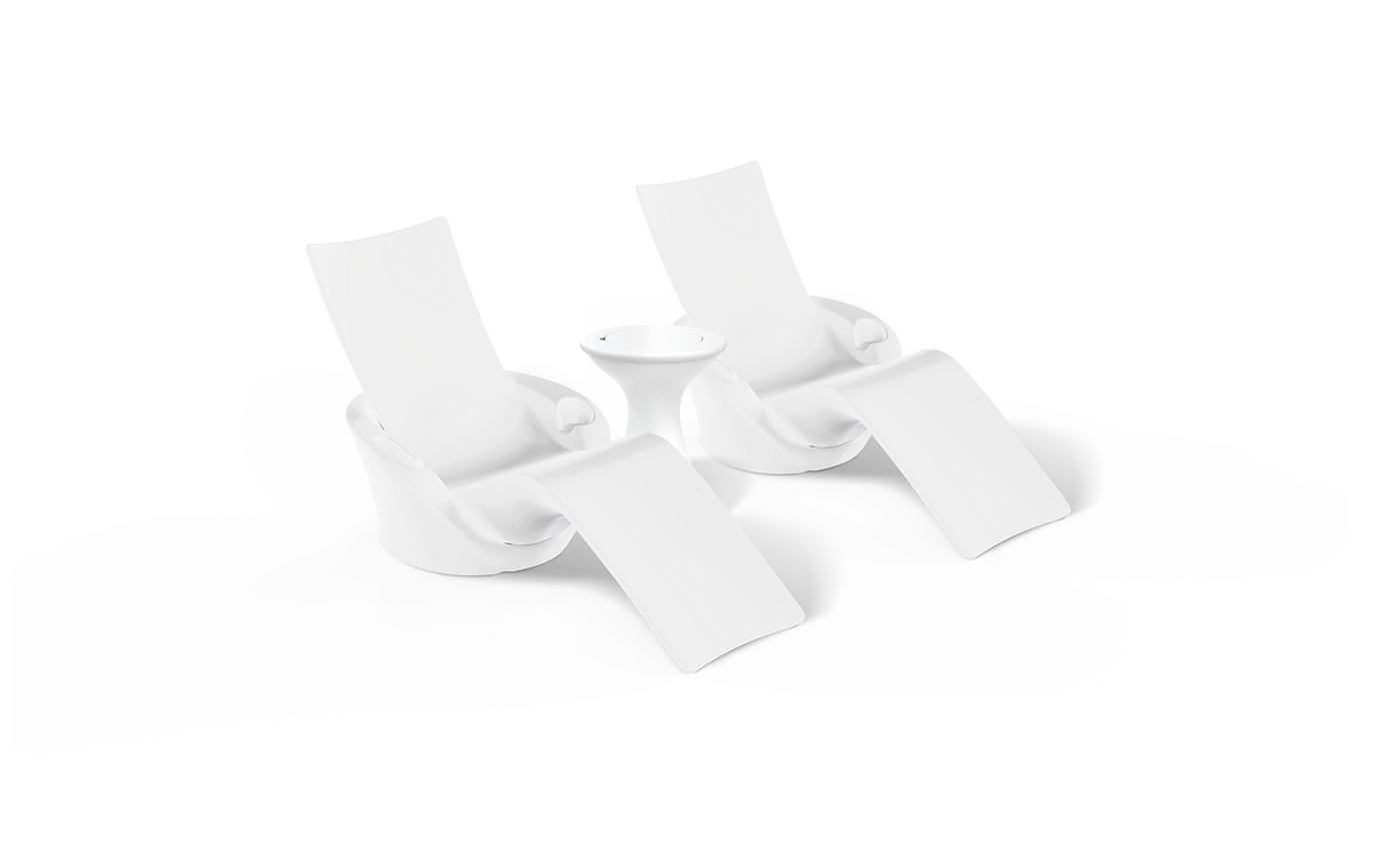 The Ledge Lounger Autograph Chaise Island Lounge Set features two modern white chaise chairs with curved seats and built-in leg rests, set side by side with a small circular white table, all on a plain white background.