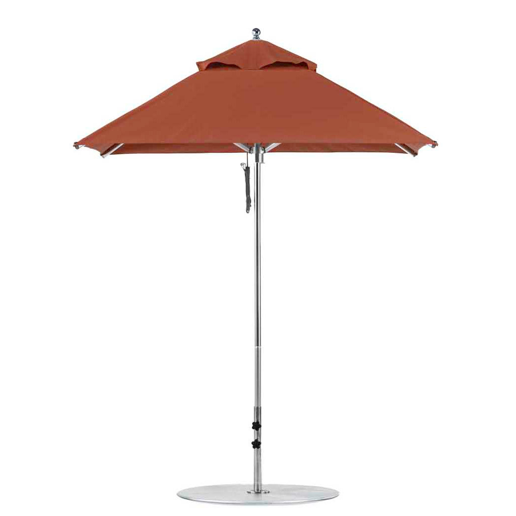 The Premier Aluminum Umbrella by Ledge Lounger features a durable frame and round base, crafted from marine-grade fabric for wind-resistance and shade. This red 6.5 square patio umbrella has a small top vent and stands isolated against a white background.