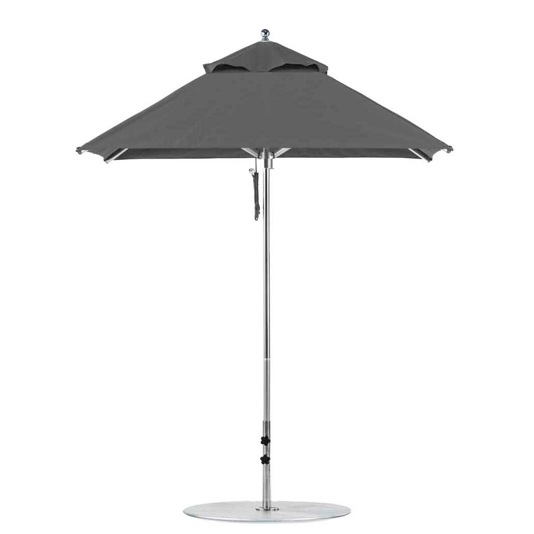 The Ledge Lounger Premier Aluminum Umbrella features a 6.5 square canopy made from marine-grade fabric for durability, mounted on a white pole with a round base. Its height-adjustable design is wind-resistant, ensuring stability and style with its vented top for enhanced airflow.