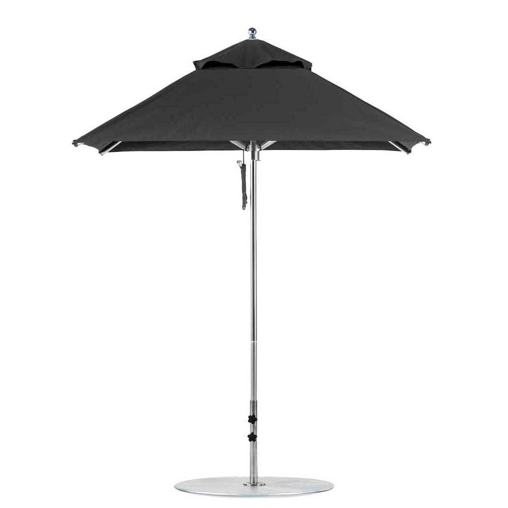 The Premier Aluminum Umbrella by Ledge Lounger, has a 6.5 square canopy crafted from marine-grade fabrics, features a central metal pole and circular base. Wind-resistant, its fully open and showcased against a white background.