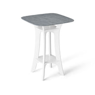 The Haven Hightop Table by Ledge Lounger features a square, light blue-grey tabletop with a white, modern base, curved legs, and a lower shelf. Its durable, minimalist design is contemporary and perfect for any patio collection.
