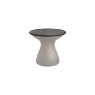 The Ledge Lounger Autograph Standard Side Table is a sleek, modern piece with a smooth hourglass-shaped base and round top. Its light gray, textured surface features a slight sheen, making it perfect for elegant poolside storage.