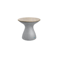 The Autograph Standard Side Table by Ledge Lounger is a small, modern stool with a sleek design. It features an hourglass-shaped gray base and a light wooden seat, perfect as an outdoor side table. Its minimalistic style complements any setting beautifully.