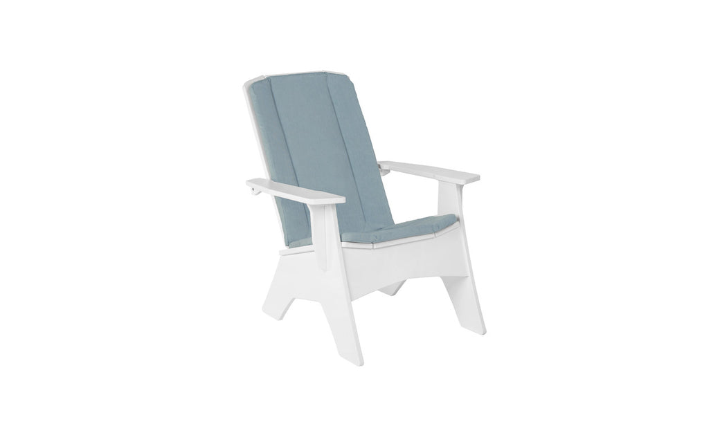 A white Adirondack chair with a Mainstay Adirondack Cushion in blue on the backrest and seat, angled slightly to the right against a white background, is perfect for outdoor spaces. Made by Ledge Lounger, it features wide armrests and a slightly reclined back for ultimate relaxation.