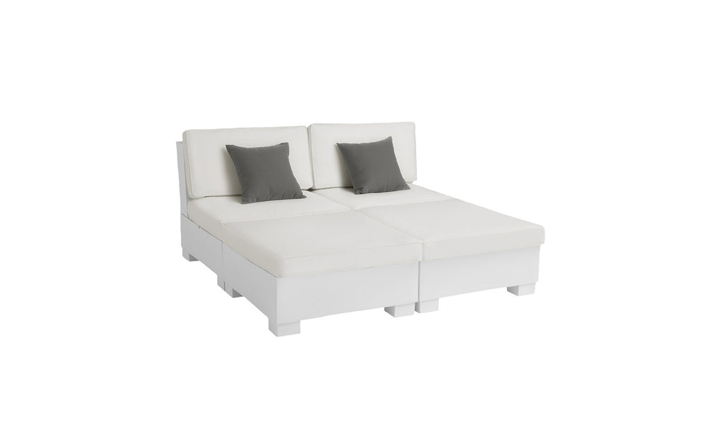 The Signature Sectional 4 Piece Sun Chair by Ledge Lounger is a modern, white, low-profile sofa with spacious seating and two sections. It comes with two gray throw pillows for added relaxation, all set against a white background.