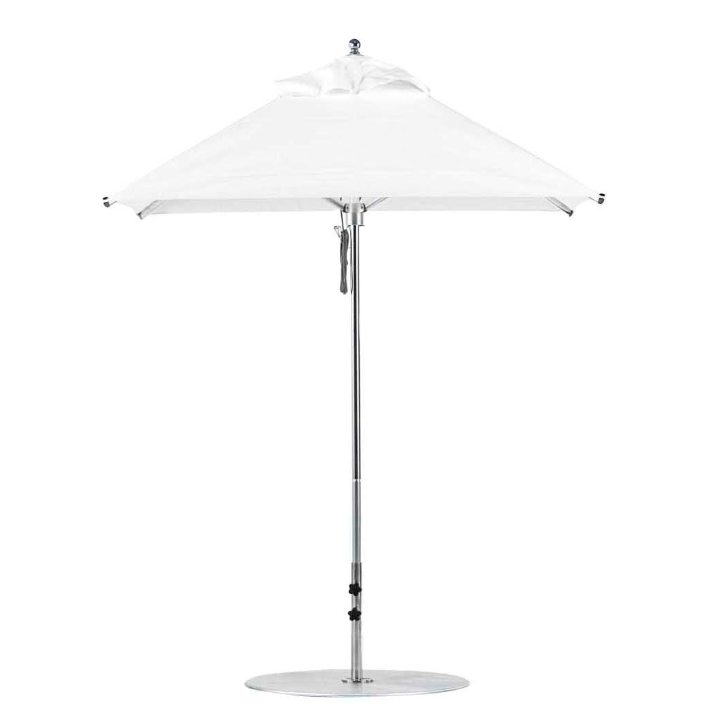 The Premier Aluminum Umbrella by Ledge Lounger features a 6.5 square canopy and a minimalist, modern design with a sleek metal pole, standing on a circular base to provide ample shade. Final Sale.