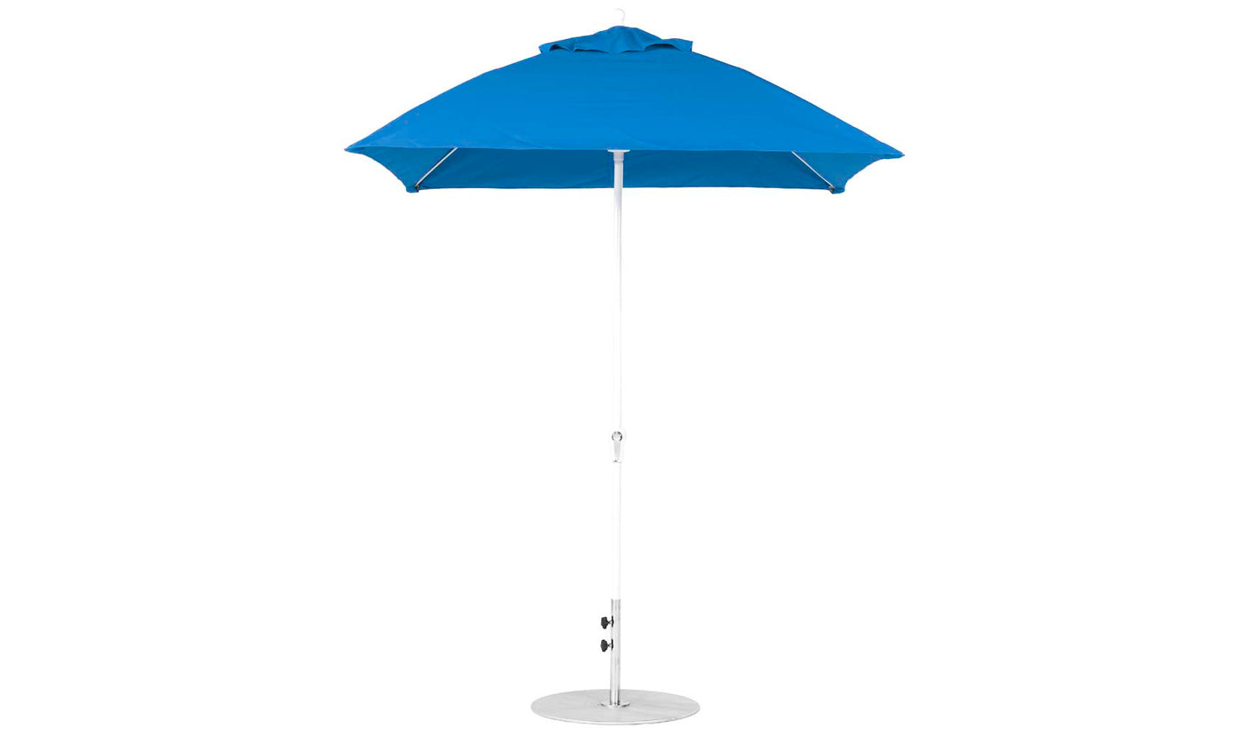 The Essential Fiberglass Umbrella by Ledge Lounger, a 6.5 square crank model with a pointed top and telescopic white pole, is secured in a round base and open to display its wide canopy against a white background. Its available as a final sale.