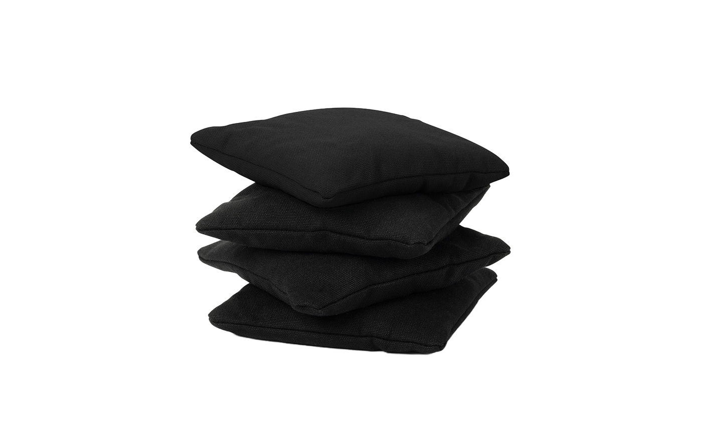 A stack of four black Bean Bags from Ledge Lounger is arranged on a white background, offering the durability and comfort of premium cushions.