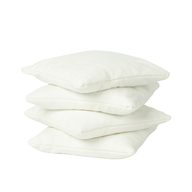 Four white, square bean bags from Ledge Lounger are stacked atop one another against a plain white background.