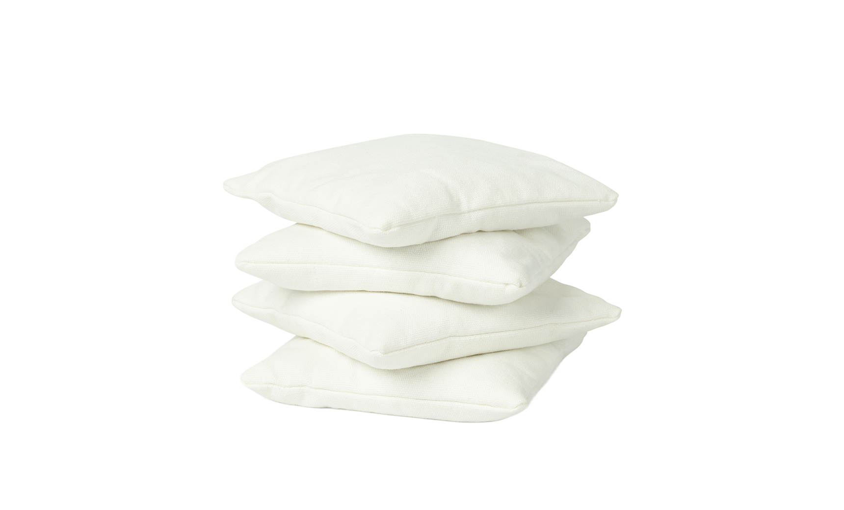 Four white, square bean bags from Ledge Lounger are stacked atop one another against a plain white background.