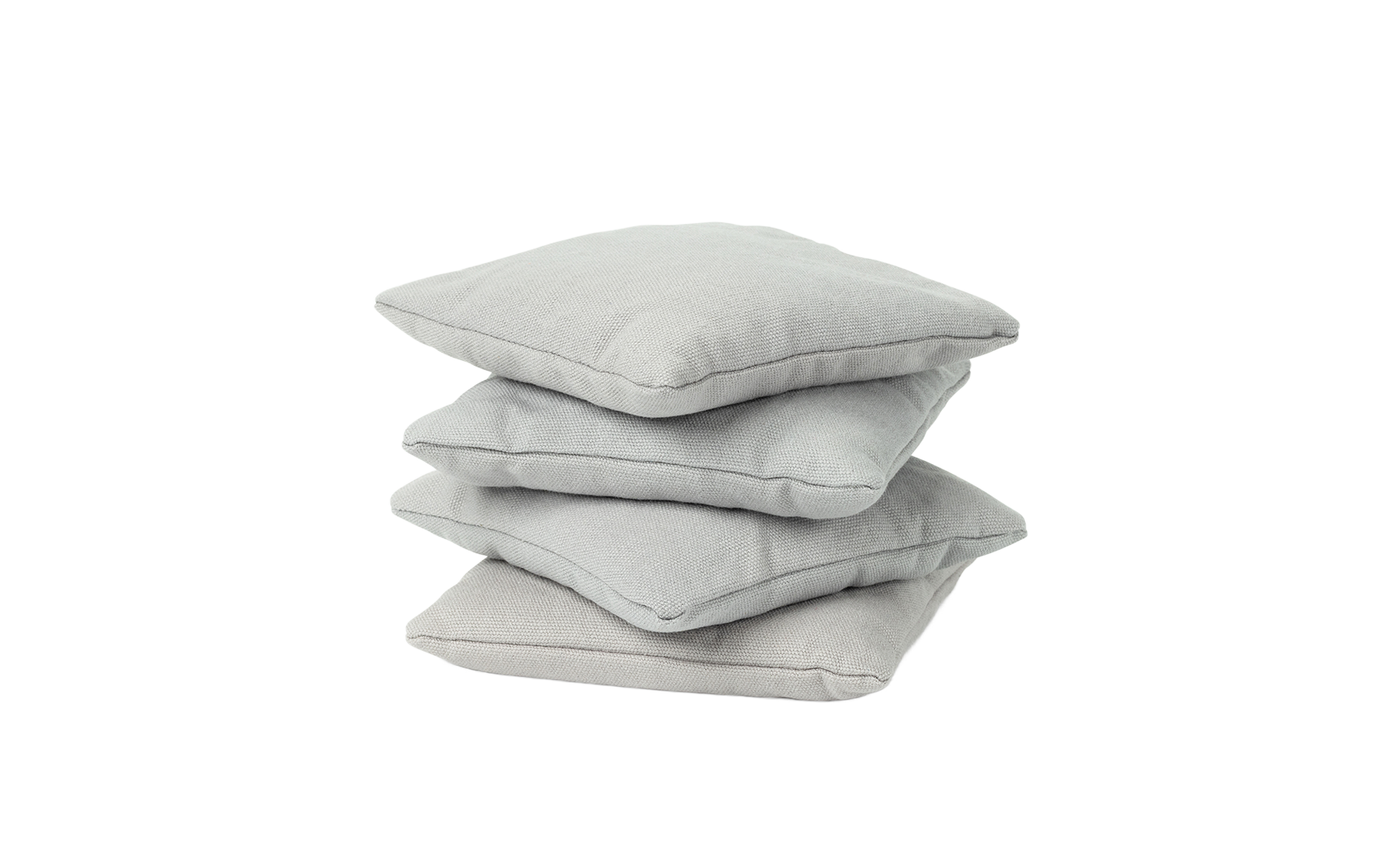 Four light gray square bean bags from Ledge Lounger are stacked against a white background.