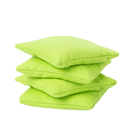 Four bright green Ledge Lounger Bean Bags are stacked together against a white background.