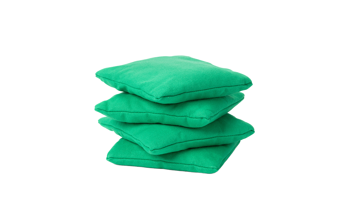 Four green Ledge Lounger bean bags are stacked on a white background, perfect for enhancing your cornhole set.