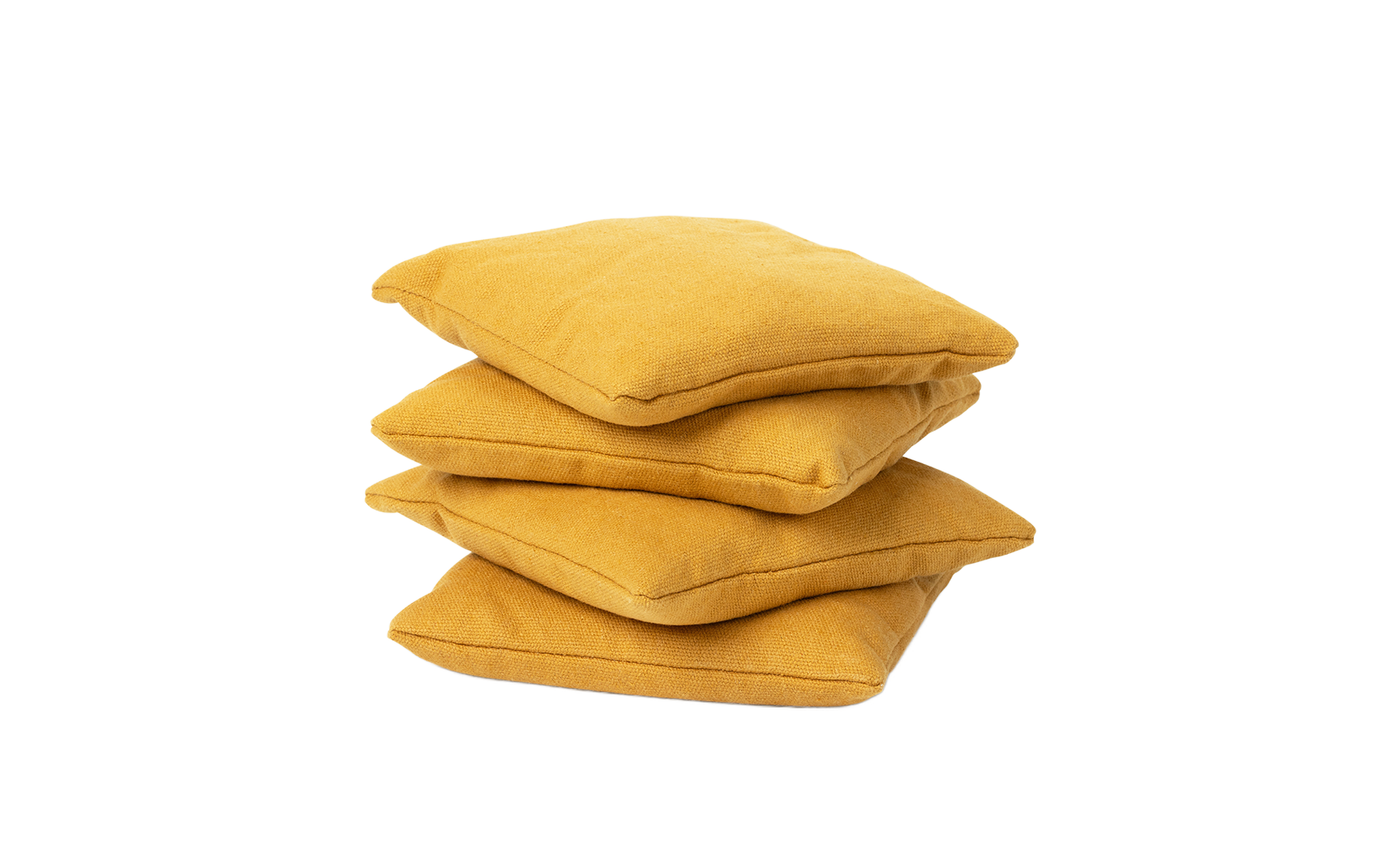 Four durable mustard yellow Ledge Lounger Bean Bags stacked together against a white background.
