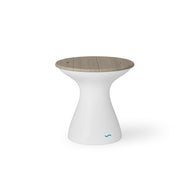 The Autograph Tall Ice Bin Side Table by Ledge Lounger is a sleek stool and outdoor side table, featuring a smooth white base with an hourglass shape and a round wooden top. A small blue logo adds flair to its versatile design, perfect for stylish spaces.