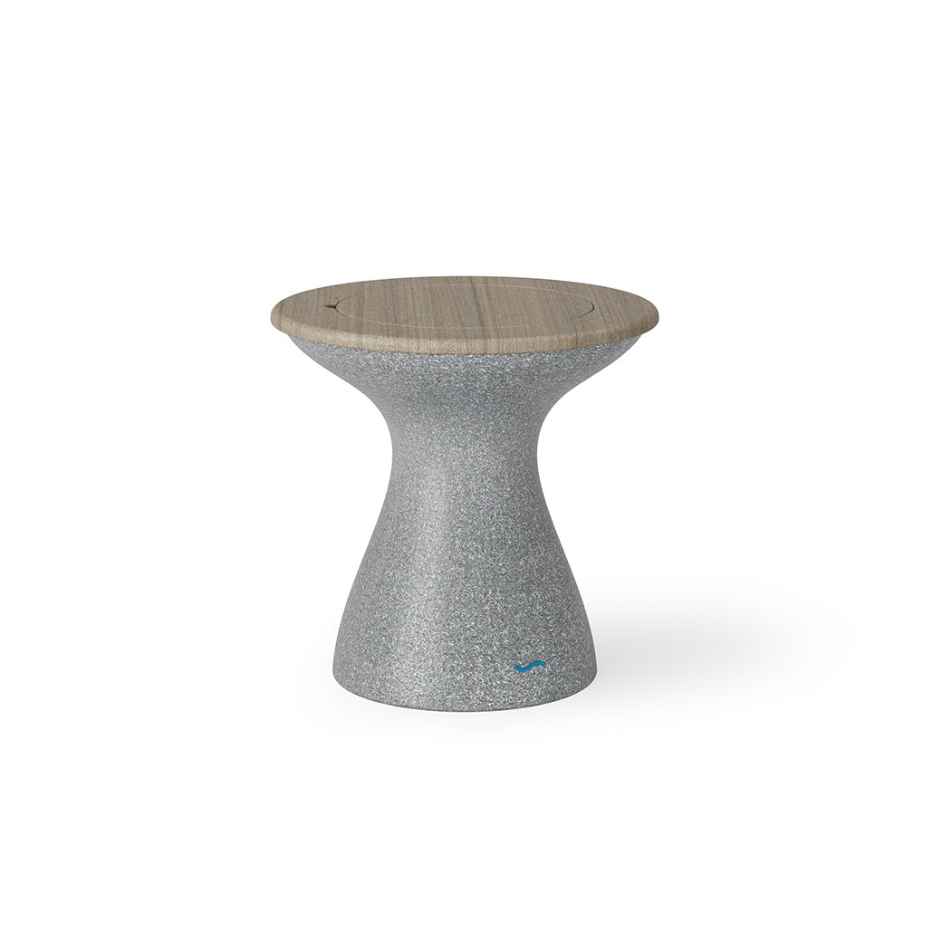 The Autograph Tall Ice Bin Side Table by Ledge Lounger features a modern design with a textured gray hourglass base and smooth wooden seat, which doubles as a chic outdoor stool.