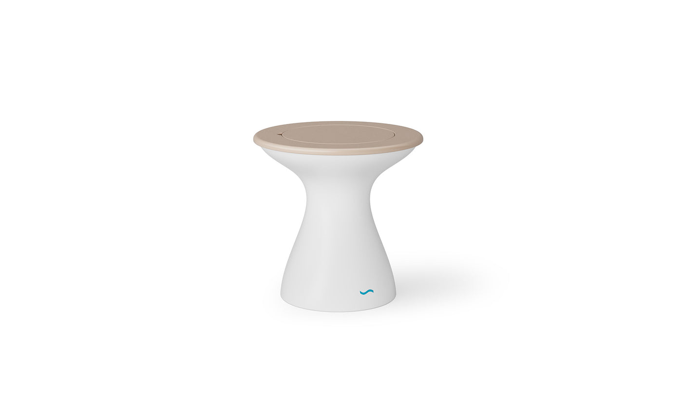 The Autograph Tall Ice Bin Side Table by Ledge Lounger is a modern, hourglass-shaped table featuring a beige circular top. Its sleek design and discreet blue logo make it a chic addition to any patio. Set against a plain white background, it adds style to outdoor settings.