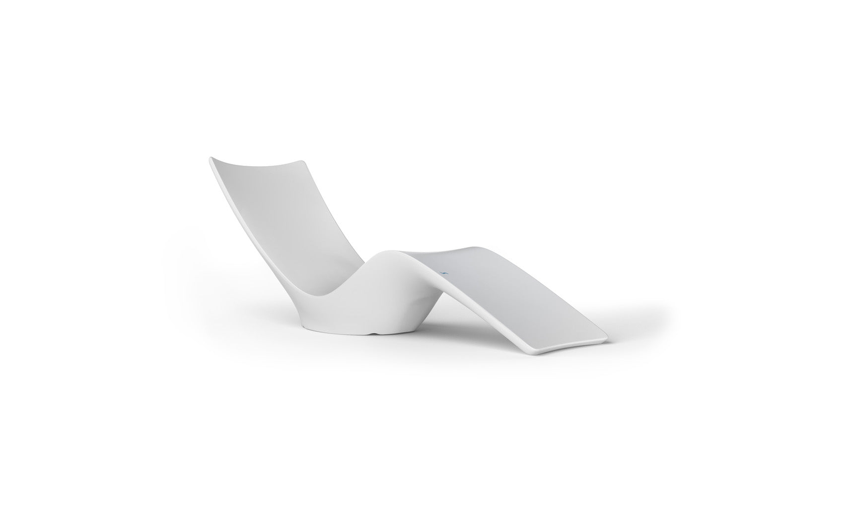 The Autograph Chaise by Ledge Lounger is a sleek, modern white outdoor lounge chair with a flowing, curved design. Ideal for poolside relaxation, it adds elegance to any space.